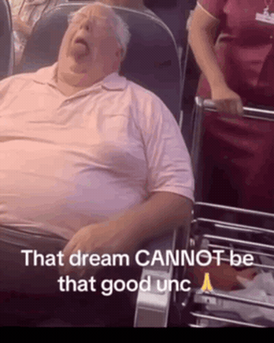 A Man In A Pink Shirt Is Sleeping In A Chair With The Words That Dream Cannot Be That Good Unc Below Him GIF