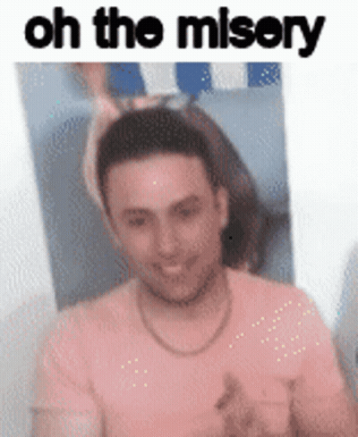 A Man In A Pink Shirt Is Smiling In Front Of A Picture Of A Woman And The Words `` Oh The Misery '' . GIF