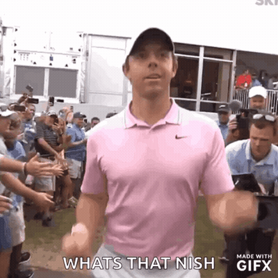 A Man In A Pink Shirt Is Standing In Front Of A Crowd And Says Whats That Nish . GIF