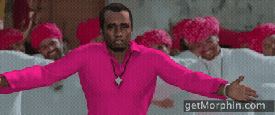 A Man In A Pink Shirt Is Standing In Front Of A Group Of Men Wearing Red Hats GIF
