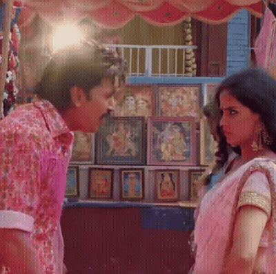 A Man In A Pink Shirt Is Standing Next To A Woman In A Pink Dress GIF