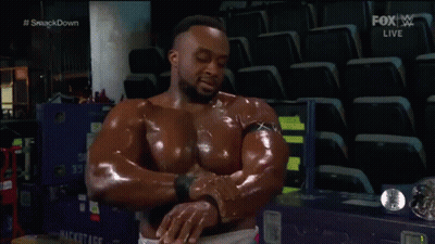 A Man In A Pink Shirt Is Standing Next To A Wrestling Wrestler . GIF