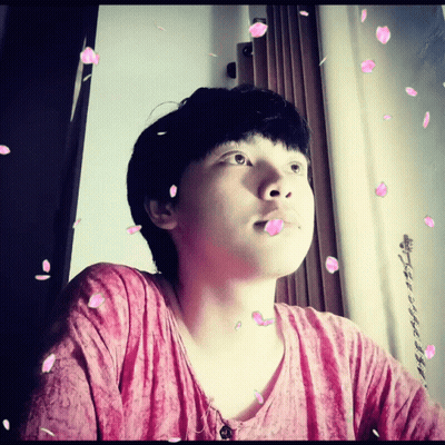 A Man In A Pink Shirt Is Surrounded By Petals GIF