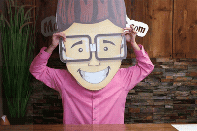 A Man In A Pink Shirt Is Wearing A Cardboard Head With Glasses On GIF