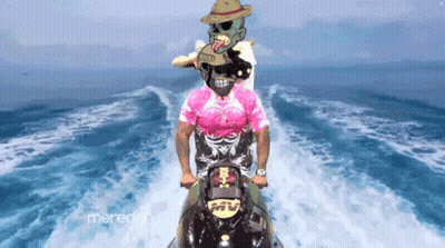 A Man In A Pink Shirt Rides A Jet Ski In The Ocean GIF