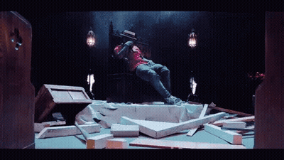 A Man In A Pink Shirt Sits On A Throne GIF