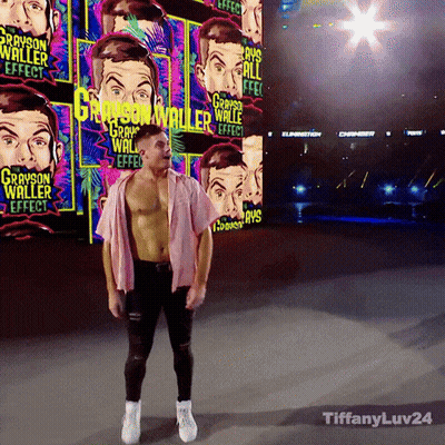 A Man In A Pink Shirt Stands In Front Of A Wall With Grayson Waller Effect Written On It GIF