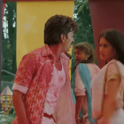 A Man In A Pink Shirt Talks To A Woman In A Pink Dress GIF