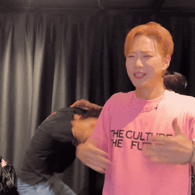 A Man In A Pink Shirt That Says The Culture Of The Future GIF