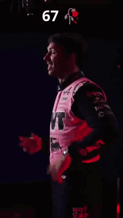 A Man In A Pink Shirt With The Number 67 On The Bottom GIF