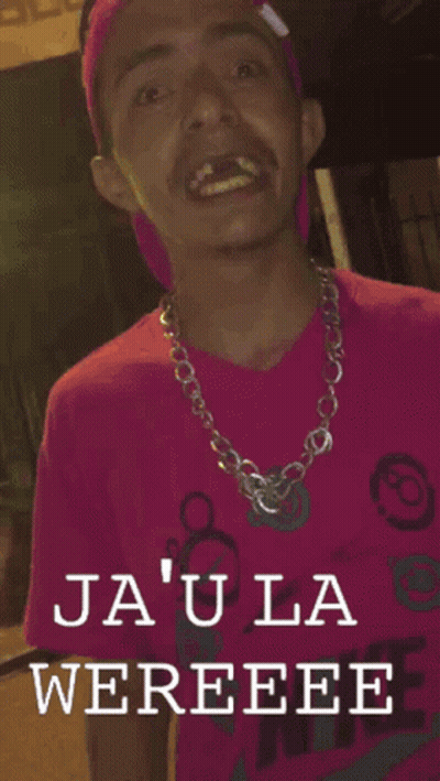 A Man In A Pink Shirt With The Words Ja ' Ula Wereee On The Bottom GIF