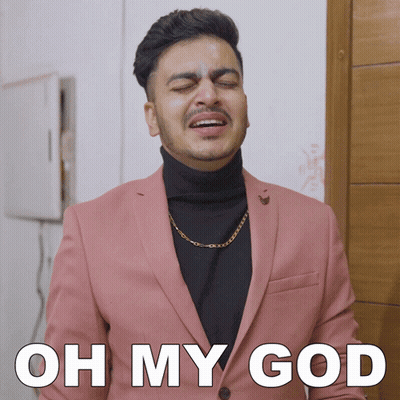 A Man In A Pink Suit And Black Turtleneck Is Making A Funny Face With The Words Oh My God Below Him GIF