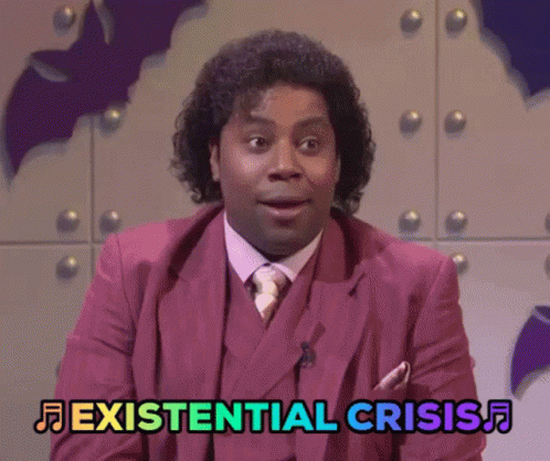 A Man In A Pink Suit And Tie Says Existential Crisis GIF