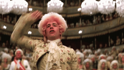 A Man In A Pink Wig Is Dancing In A Theater GIF