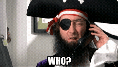 A Man In A Pirate Costume Is Talking On A Cell Phone And Says Who ? GIF