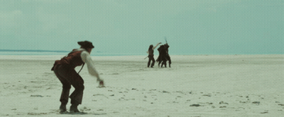 A Man In A Pirate Costume Is Walking On A Beach GIF