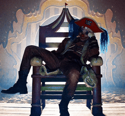 A Man In A Pirate Costume Sits On A Chair GIF