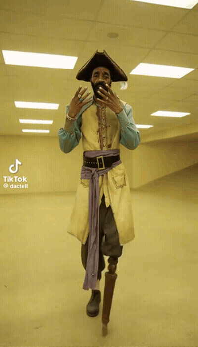 A Man In A Pirate Costume With A Prosthetic Leg Takes A Picture Of Himself GIF