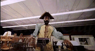 A Man In A Pirate Outfit Is Standing In A Room GIF
