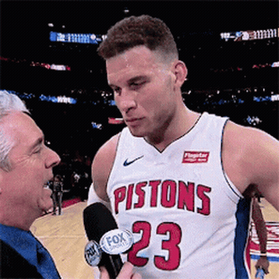 A Man In A Pistons Jersey Is Being Interviewed By A Fox Reporter GIF