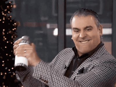 A Man In A Plaid Jacket Holds A Shaker In His Hand GIF