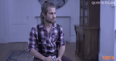 A Man In A Plaid Shirt And Suspenders Sits On A Couch With The Words Quinte Flush On The Bottom GIF