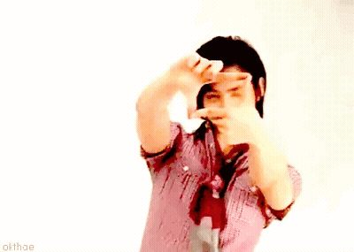 A Man In A Plaid Shirt And Tie Is Making A Frame With His Hands GIF