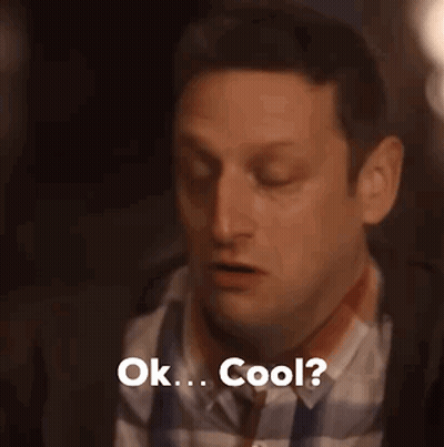 A Man In A Plaid Shirt And Tie Is Saying Ok . Cool . GIF