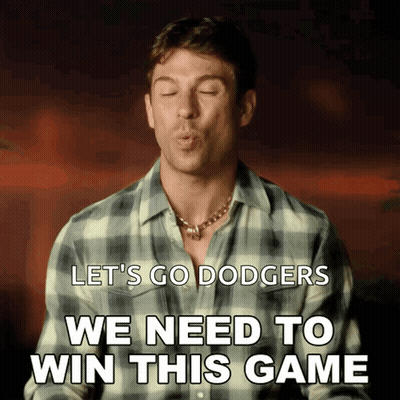 A Man In A Plaid Shirt Blows A Kiss With The Words Let 'S Go Dodgers We Need To Win This Game Below Him GIF