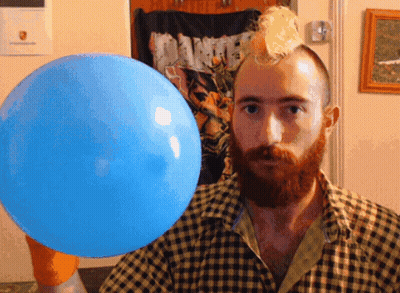 A Man In A Plaid Shirt Holds A Blue Balloon GIF