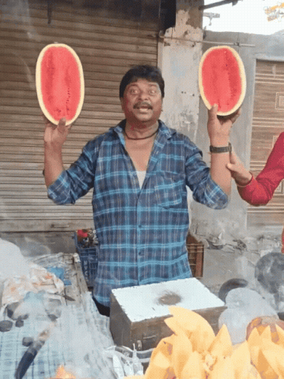 A Man In A Plaid Shirt Holds Two Slices Of Watermelon In His Hands GIF