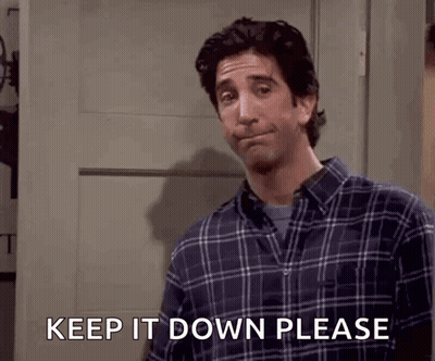 A Man In A Plaid Shirt Is Asking To Keep It Down Please GIF