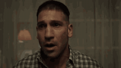 A Man In A Plaid Shirt Is Crying While Holding A Box In His Hand . GIF