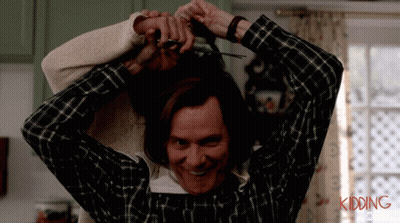 A Man In A Plaid Shirt Is Cutting A Woman 'S Hair With The Words Kidding Written On The Bottom GIF
