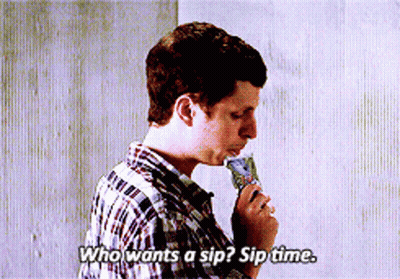 A Man In A Plaid Shirt Is Eating An Ice Cream Cone And Says Who Wants A Sip GIF