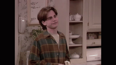 A Man In A Plaid Shirt Is Holding A Banana GIF