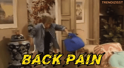 A Man In A Plaid Shirt Is Holding A Blue Bag With The Words Back Pain Written Above Him GIF