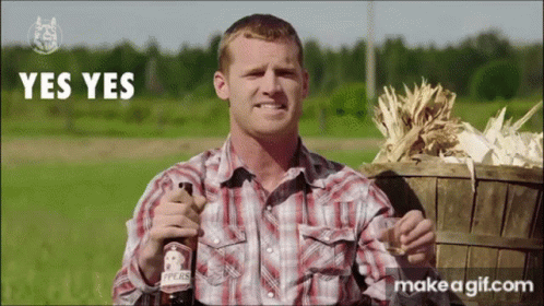 A Man In A Plaid Shirt Is Holding A Bottle Of Pears GIF