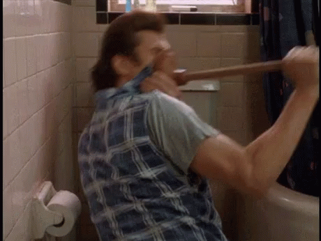A Man In A Plaid Shirt Is Holding A Plunger In His Hand GIF