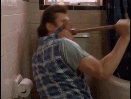 A Man In A Plaid Shirt Is Holding A Plunger In His Mouth In A Bathroom . GIF