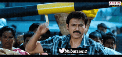 A Man In A Plaid Shirt Is Holding A Yellow And Black Pole In Front Of A Crowd Of People And A Twitter Logo GIF
