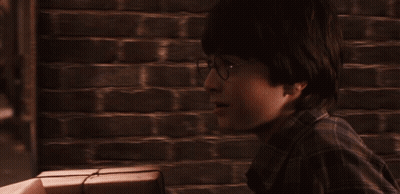 A Man In A Plaid Shirt Is Looking At Something In The Distance GIF