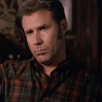A Man In A Plaid Shirt Is Making A Silly Face GIF