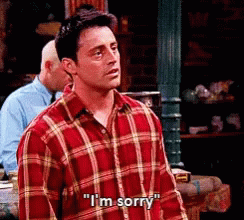 A Man In A Plaid Shirt Is Saying I 'M Sorry GIF