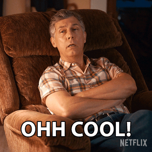 A Man In A Plaid Shirt Is Sitting In A Chair With His Arms Crossed And The Words Ohh Cool Written Below Him GIF