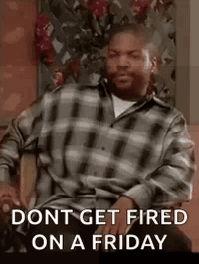 A Man In A Plaid Shirt Is Sitting In A Chair With The Words `` Dont Get Fired On A Friday '' . GIF