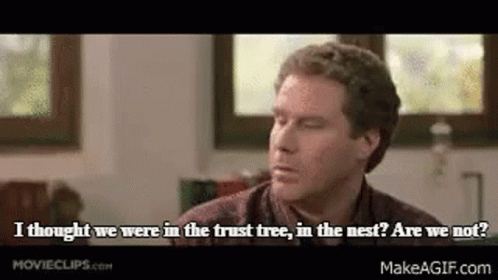 A Man In A Plaid Shirt Is Sitting In Front Of A Window And Talking To Someone . GIF