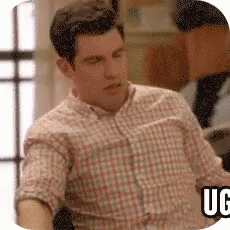 A Man In A Plaid Shirt Is Sitting In Front Of A Window With A Sticker That Says Ugg GIF