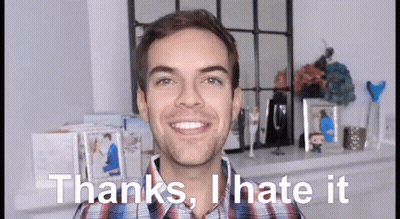 A Man In A Plaid Shirt Is Smiling And Saying Thanks , I Hate It GIF