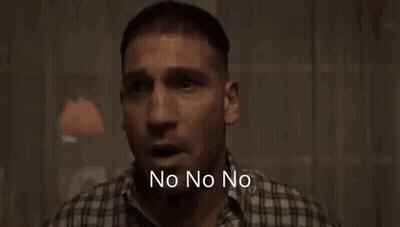A Man In A Plaid Shirt Is Standing In A Dark Room With The Words Wait Wait Wait Wait Written Below Him . GIF